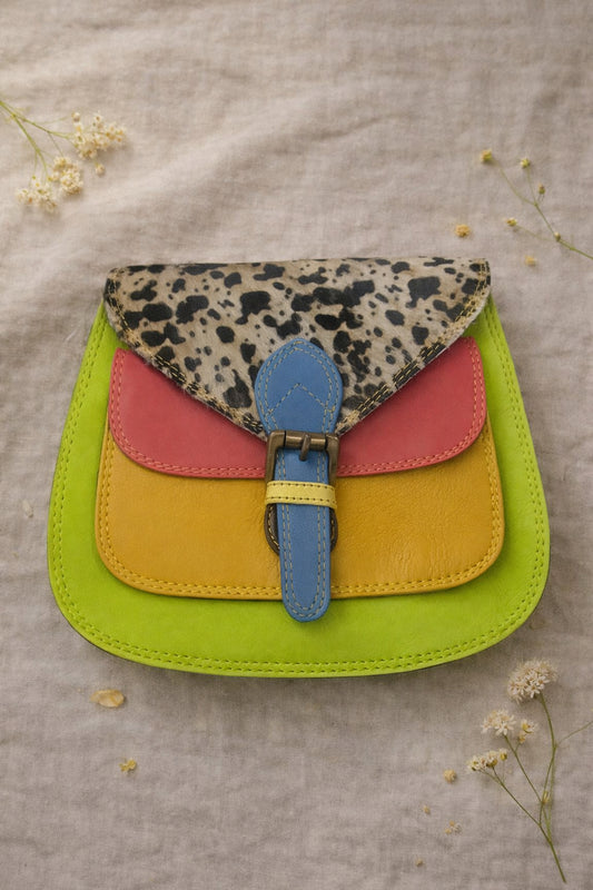 Handmade Leather Crossbody Bag featuring vibrant colors and a unique design with a spotted flap and buckle closure.