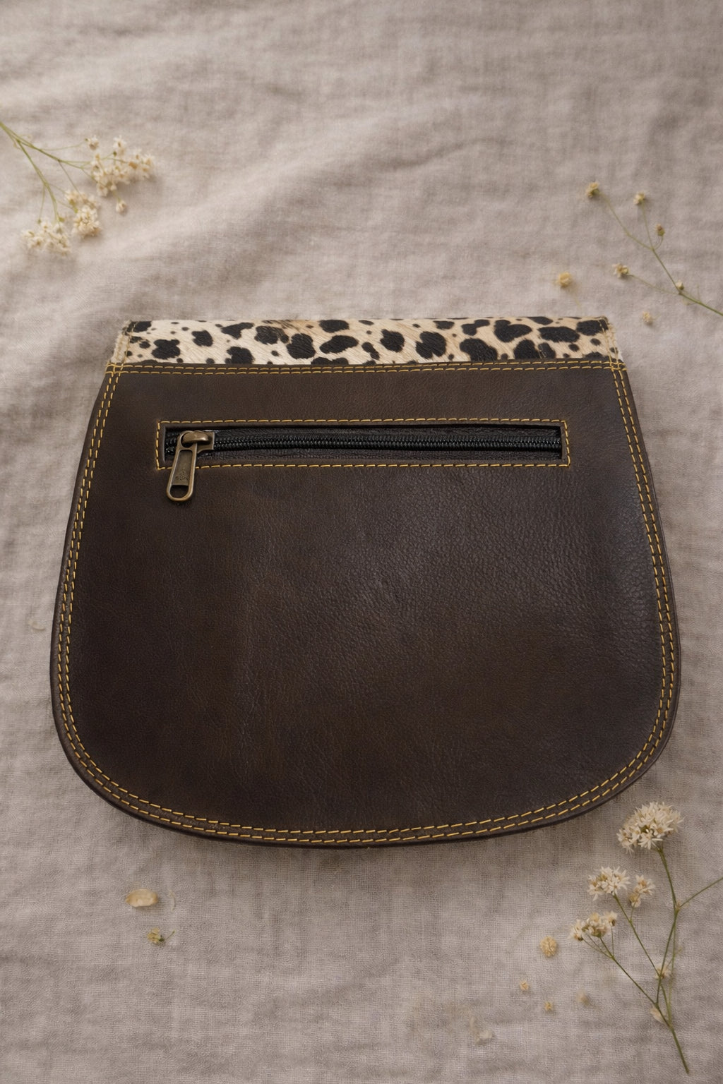 Handmade Leather Crossbody Bag featuring vibrant colors and a unique design with a spotted flap and buckle closure.