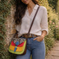 Handmade Leather Crossbody Bag featuring vibrant colors and a unique design with a spotted flap and buckle closure.