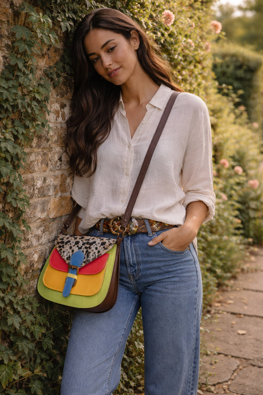 Handmade Leather Crossbody Bag featuring vibrant colors and a unique design with a spotted flap and buckle closure.
