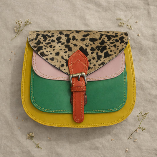 Handmade Leather Crossbody Bag - Romy with colorful panels and animal print flap on a light background.