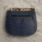 Handmade Leather Crossbody Bag - Romy with colorful panels and animal print flap on a light background.