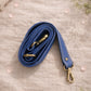 Handmade Leather Crossbody Bag - Romy - Walled Garden - Primrose displayed on soft fabric with flower petals around.