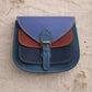 Handmade Leather Crossbody Bag - Romy in walled garden colors, featuring a stylish buckle and floral accents.