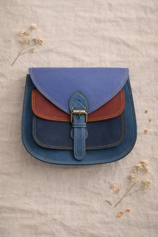 Handmade Leather Crossbody Bag - Romy in walled garden colors, featuring a stylish buckle and floral accents.