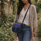 Handmade Leather Crossbody Bag - Romy in walled garden colors, featuring a stylish buckle and floral accents.