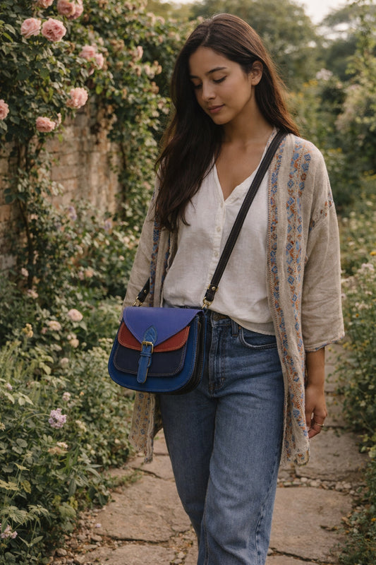 Handmade Leather Crossbody Bag - Romy in walled garden colors, featuring a stylish buckle and floral accents.