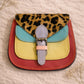 Handmade Leather Crossbody Bag featuring vibrant colors and leopard print flap, perfect for stylish outings.