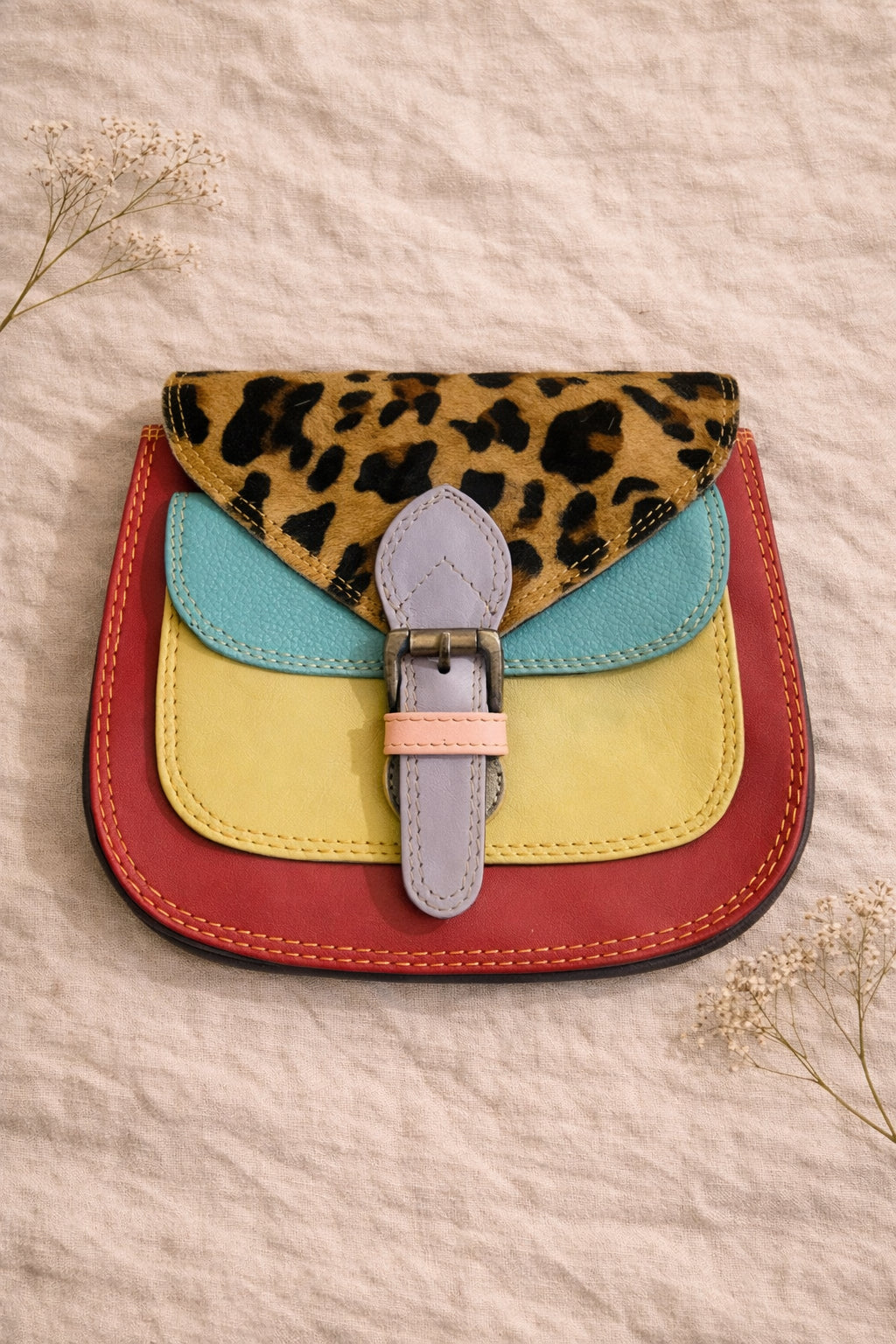 Handmade Leather Crossbody Bag featuring vibrant colors and leopard print flap, perfect for stylish outings.