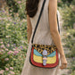 Handmade Leather Crossbody Bag featuring vibrant colors and leopard print flap, perfect for stylish outings.