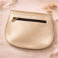 Handmade Leather Crossbody Bag - Romy - Aurelia in metallic gold finish on a sparkling background.
