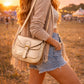 Handmade Leather Crossbody Bag - Romy - Aurelia in metallic gold finish on a sparkling background.
