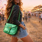 Handmade Leather Crossbody Bag in vibrant green worn at a festival, giving a stylish and fun vibe.