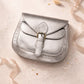 Handmade Leather Crossbody Bag - Romy - Aurum in metallic silver, surrounded by decorative elements and soft ribbons.