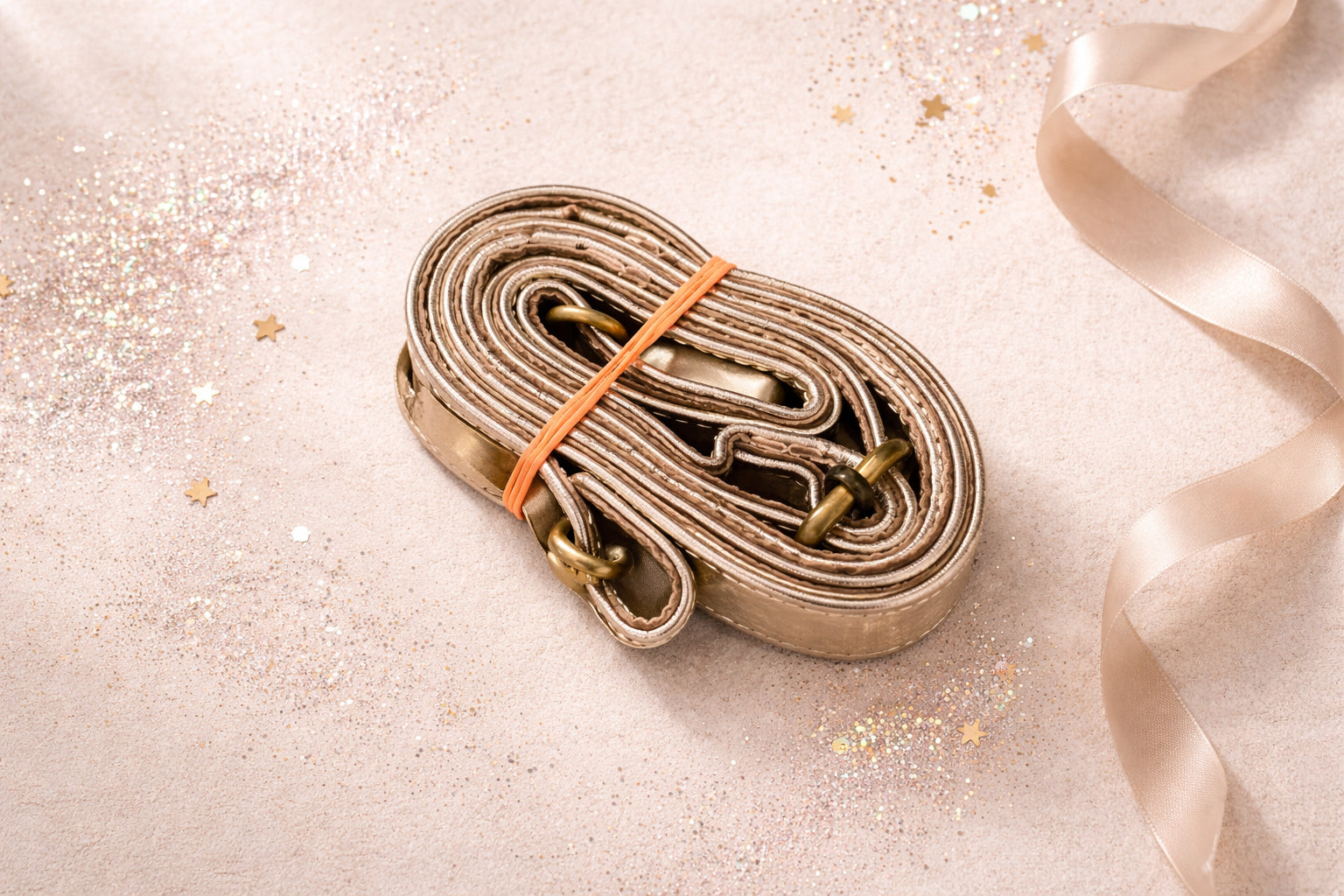 Handmade Leather Crossbody Bag - Romy - Aurum in metallic silver, surrounded by decorative elements and soft ribbons.
