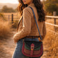 Handmade Leather Crossbody Bag - Romy featuring multiple colors and a stylish buckle strap on a textured background.