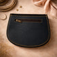 Handmade Leather Crossbody Bag - Romy featuring multiple colors and a stylish buckle strap on a textured background.
