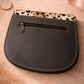 Handmade Leather Crossbody Bag featuring vibrant colors and a unique spotted design on the flap.