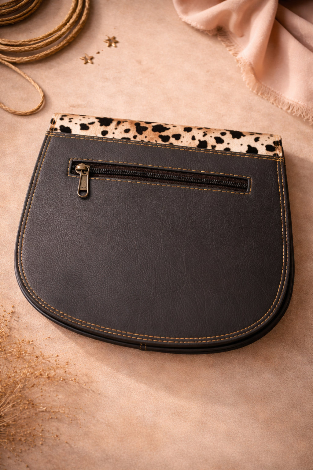 Handmade Leather Crossbody Bag featuring vibrant colors and a unique spotted design on the flap.