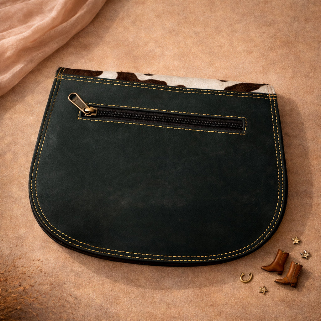 Model wearing a Handmade Leather Crossbody Bag, the Romy, in a scenic outdoor setting at sunrise.