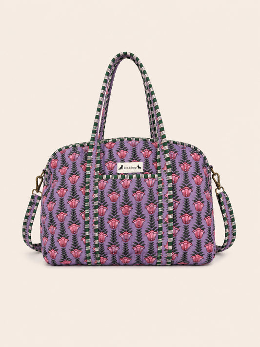 Handmade duffle bag featuring a vibrant seashell print on quilted cotton, perfect for stylish everyday use.