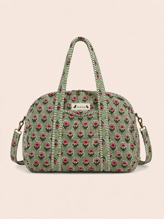 Handmade duffle bag featuring a floral pattern in soft quilted cotton, perfect for travel and everyday use.