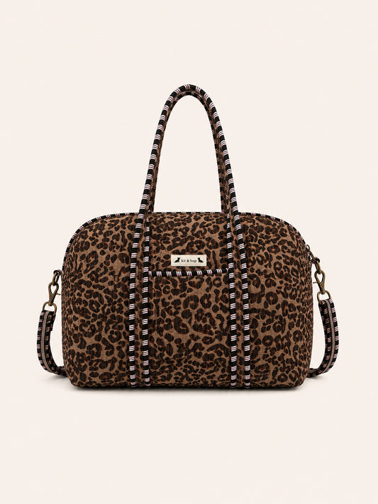 Handmade duffle bag featuring a stylish leopard print pattern, perfect for travel and everyday use.